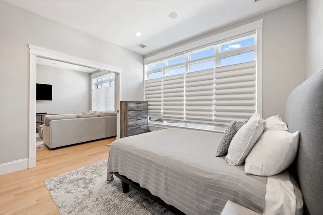 a bedroom with a bed and a couch