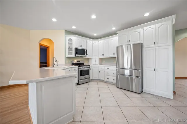 a kitchen with stainless steel appliances a refrigerator sink microwave and cabinets