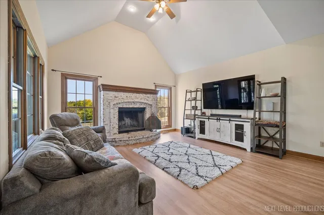 a living room with furniture a flat screen tv and a fireplace