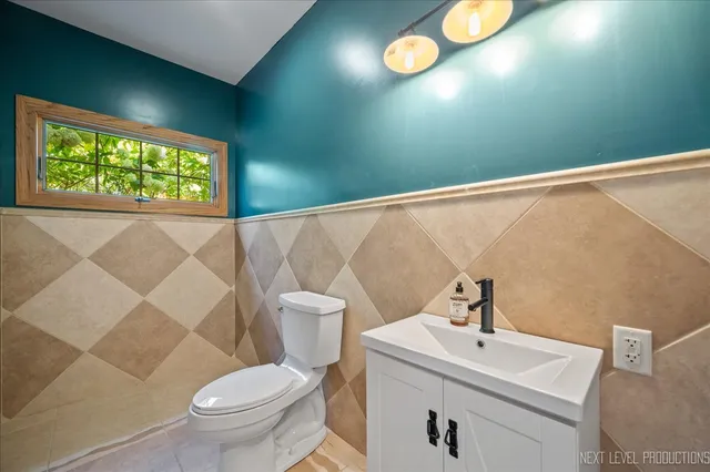 a bathroom with a toilet a sink and a window