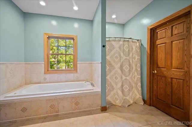 a bathroom with a bathtub and shower