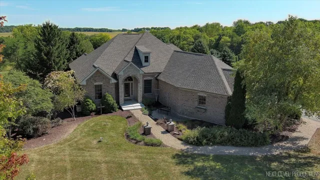 an aerial view of a house with a yard