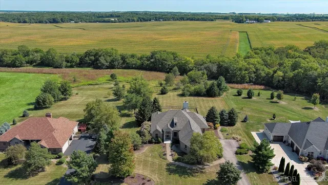 a aerial view of a house with outdoor space and lake view