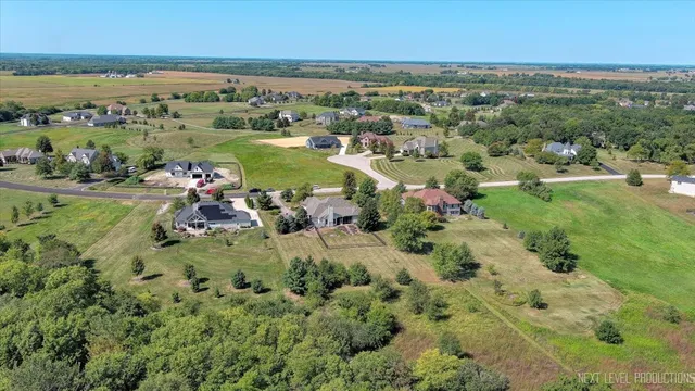 a view of a field with trees in the background