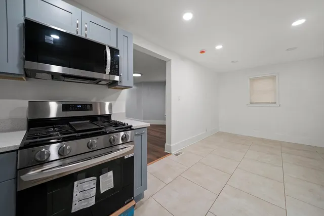 a stove top oven sitting inside of a kitchen