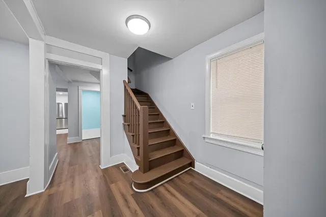 wooden floor in a hall with a window