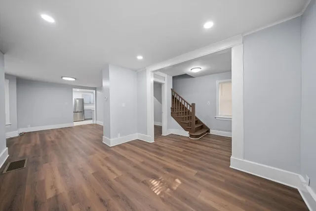 a view of a room with wooden floor and stairs