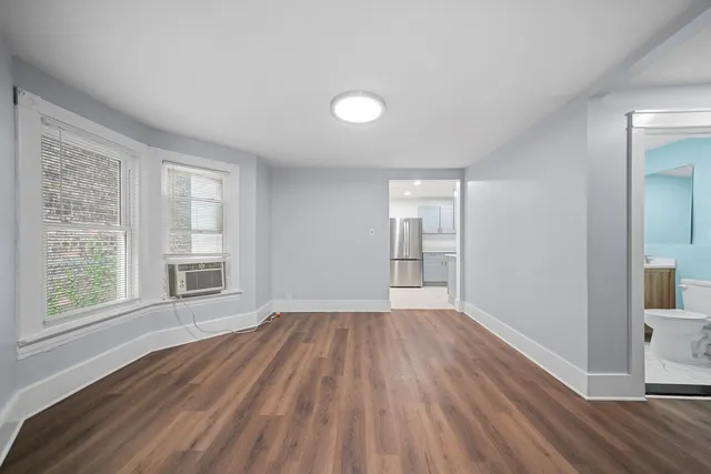 wooden floor in an empty room with a window