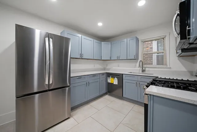 a kitchen with stainless steel appliances granite countertop a refrigerator sink and cabinets