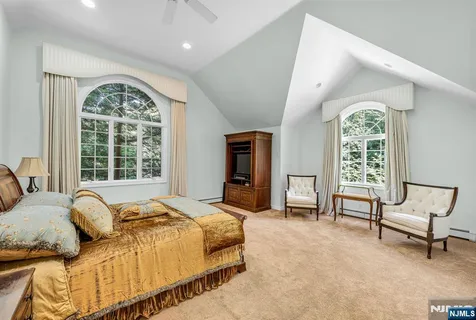 a spacious bedroom with a bed and a window