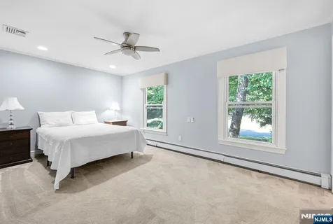 a spacious bedroom with a large bed and a window