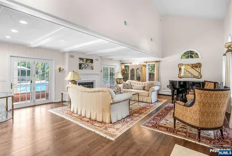 a living room with furniture a fireplace and a large window
