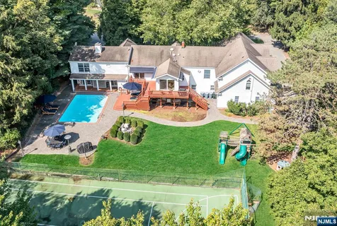 an aerial view of a house with swimming pool garden and patio