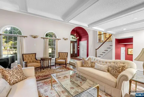 a living room with furniture a chandelier and a window