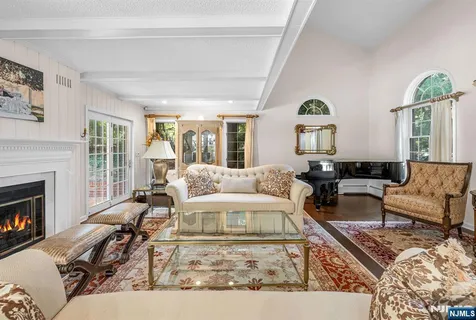 a living room with furniture a fireplace and a table