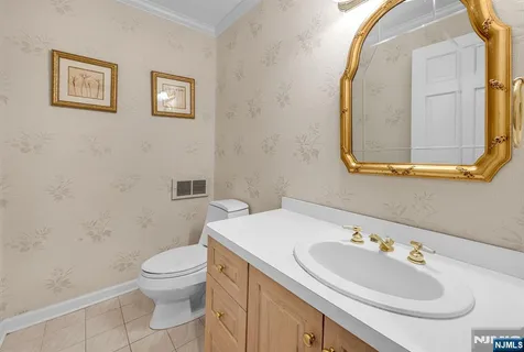 a bathroom with a sink mirror and toilet