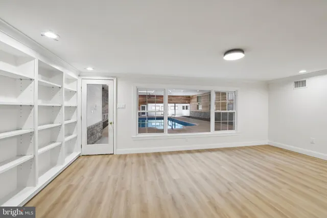 a view of wooden floor and windows in a room