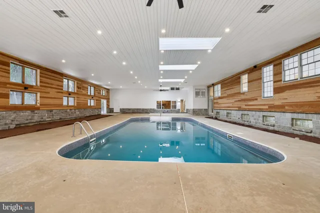 a kitchen with stainless steel appliances granite countertop a sink a counter top space and a large window