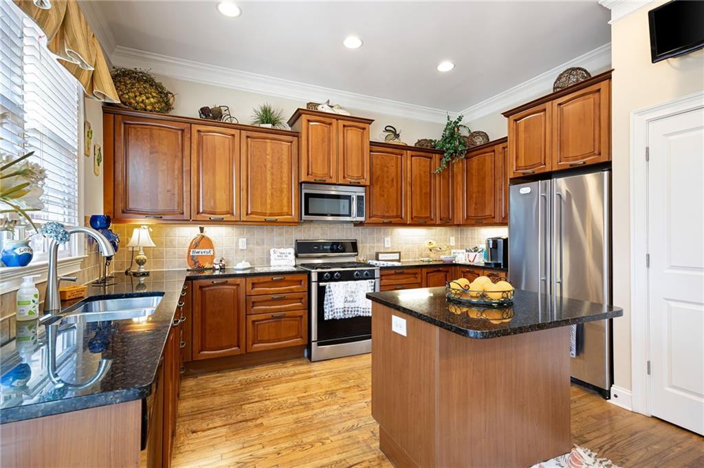 2354 St Davids Square, Unit 3 Kennesaw, GA 30152 - Photo 13 of 39 a kitchen with granite countertop stainless steel appliances and wooden cabinets