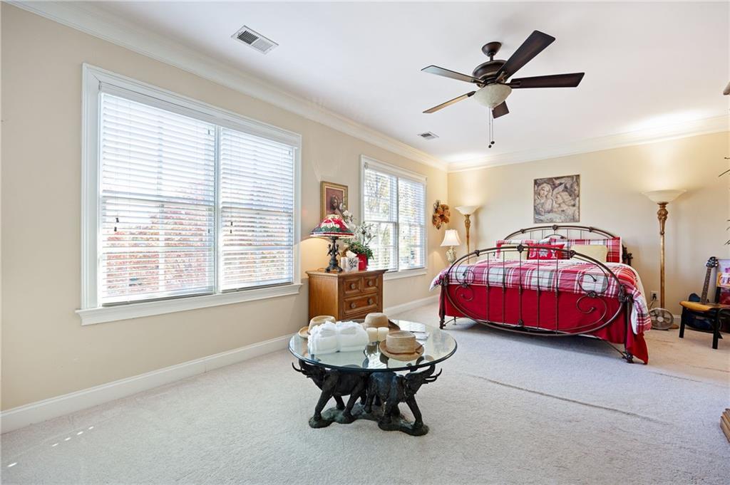 2354 St Davids Square, Unit 3 Kennesaw, GA 30152 - Photo 25 of 39 a bedroom with a bed and a chandelier