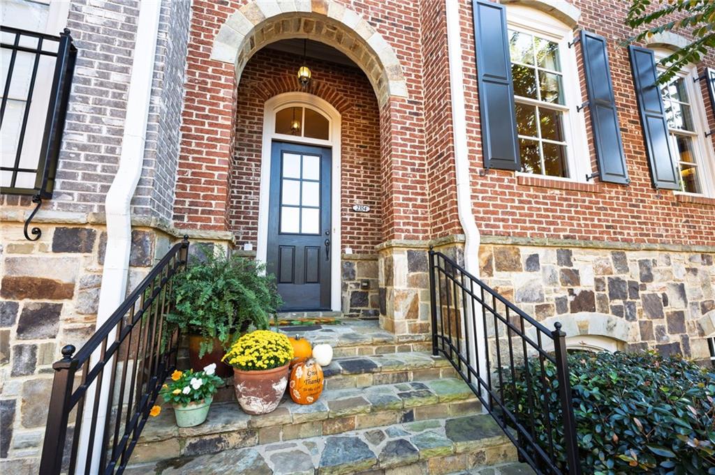 2354 St Davids Square, Unit 3 Kennesaw, GA 30152 - Photo 4 of 39 a view of a brick house with many windows and plants