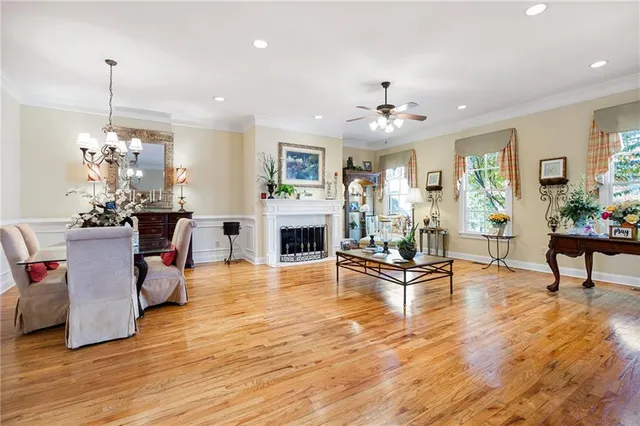 a living room with furniture a fireplace and a chandelier