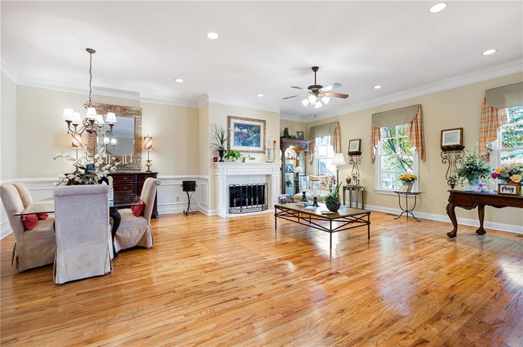 2354 St Davids Square, Unit 3 Kennesaw, GA 30152 - Photo 7 of 39 a living room with furniture a fireplace and a chandelier