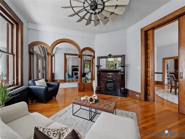 a living room with fireplace furniture and a wooden floor