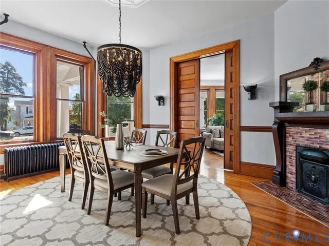 a dining room with furniture window and wooden floor