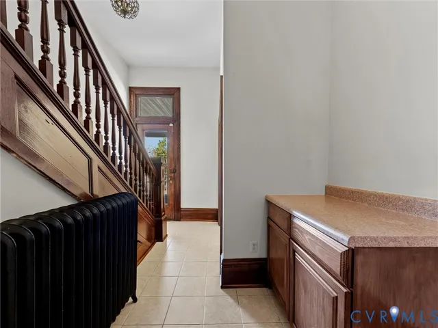 a utility room with dryer and stairs