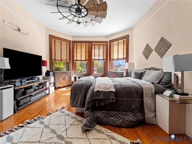 a bedroom with a bed and flat screen tv