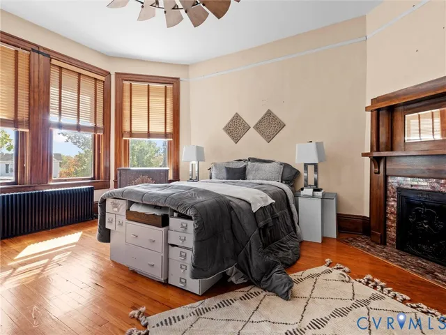 a spacious bedroom with a bed and a fireplace