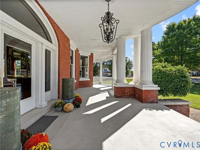 a building outdoor space with patio furniture and potted plants