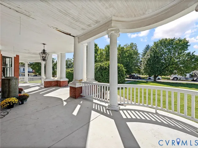 a view of a patio with a table chairs next to a yard