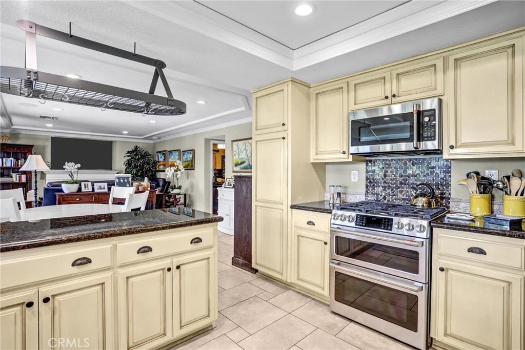5787 Ridgeway Road Rancho Cucamonga, CA 91701 - Photo 14 of 56 a kitchen with white cabinets and appliances