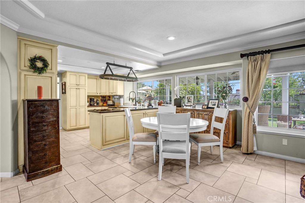 5787 Ridgeway Road Rancho Cucamonga, CA 91701 - Photo 18 of 56 a kitchen with a dining table chairs and refrigerator