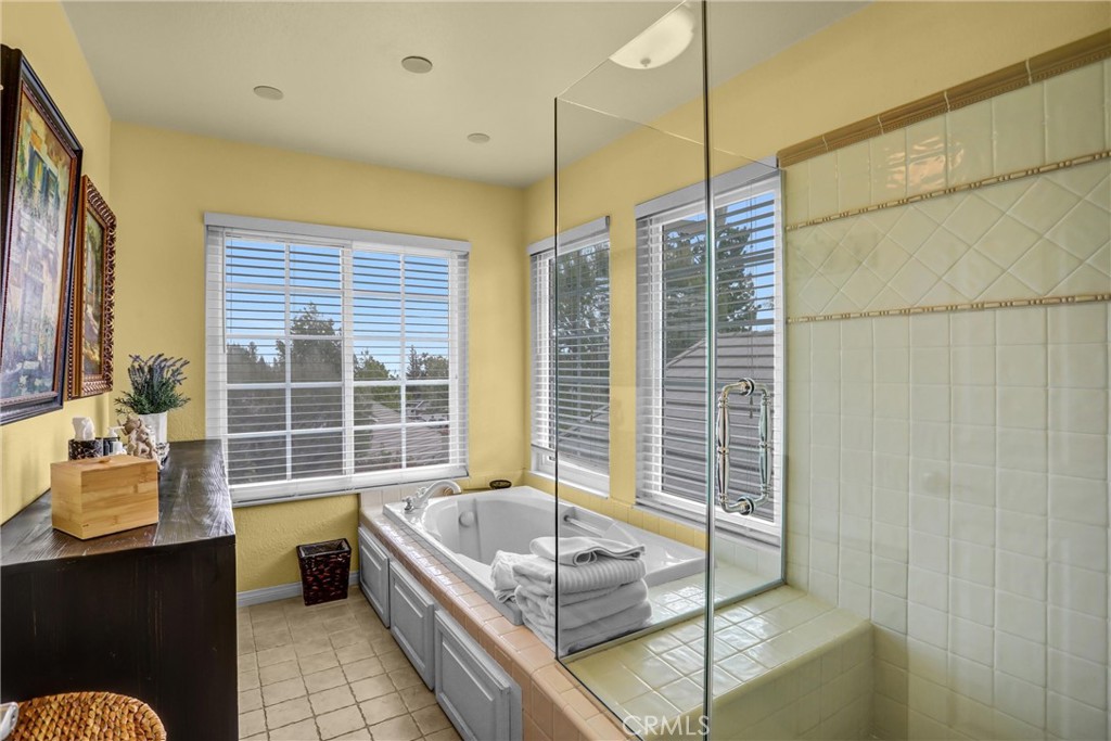 5787 Ridgeway Road Rancho Cucamonga, CA 91701 - Photo 31 of 56 a bathroom with a tub a window and potted plant