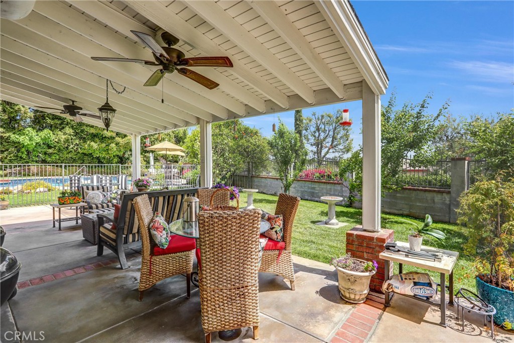 5787 Ridgeway Road Rancho Cucamonga, CA 91701 - Photo 36 of 56 a view of a patio with table and chairs potted plants with wooden floor and fence