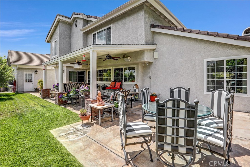 5787 Ridgeway Road Rancho Cucamonga, CA 91701 - Photo 38 of 56 a view of a patio with table and chairs and potted plants