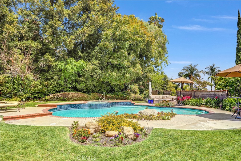 5787 Ridgeway Road Rancho Cucamonga, CA 91701 - Photo 40 of 56 a view of pool and trees in the background