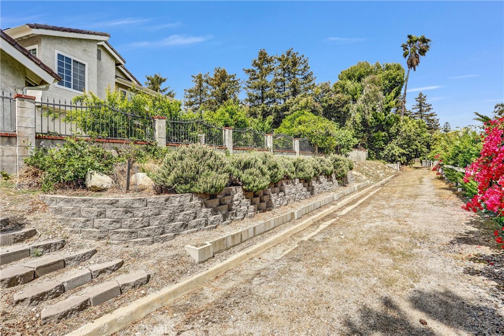 5787 Ridgeway Road Rancho Cucamonga, CA 91701 - Photo 47 of 56 a view of a pathway with a house in the background