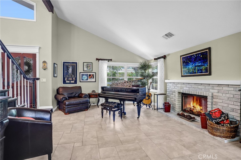 5787 Ridgeway Road Rancho Cucamonga, CA 91701 - Photo 9 of 56 a living room with furniture a flat screen tv and a fireplace