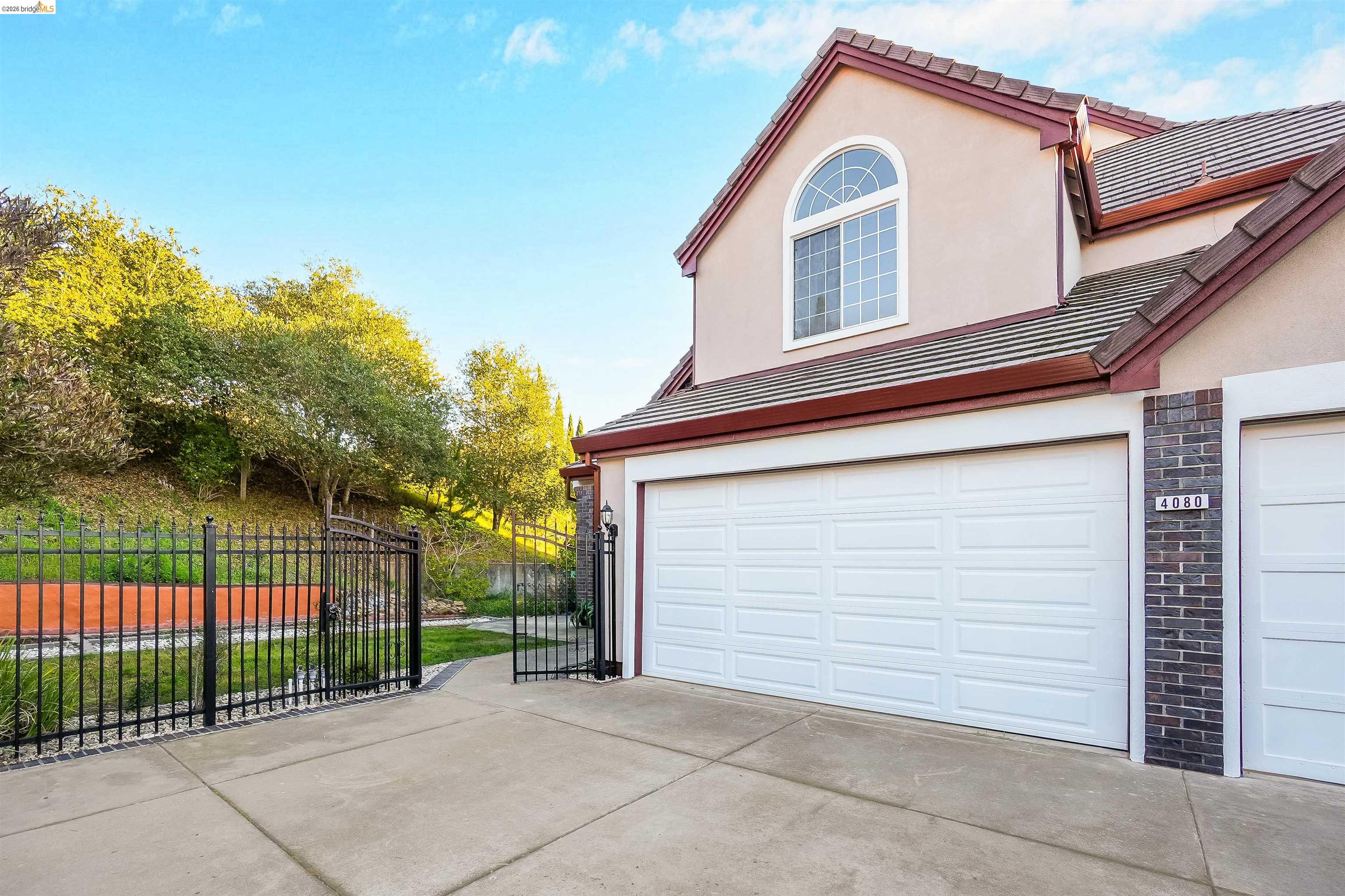 4080 Woodstock Road Hayward, CA 94542 - Photo 3 of 52 a view of a house with a small yard and a large parking space