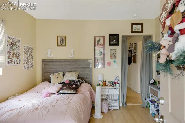 a bed room with a bed and a chair