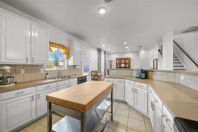 a kitchen with a sink stove and cabinets