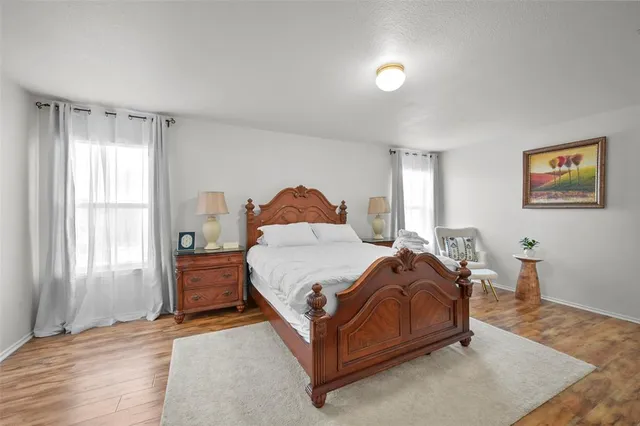 a bed sitting in a bedroom next to a window