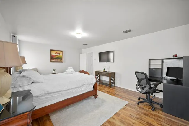 a bedroom with a bed a desk and chair