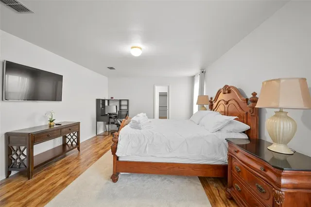 a bedroom with furniture and a flat screen tv