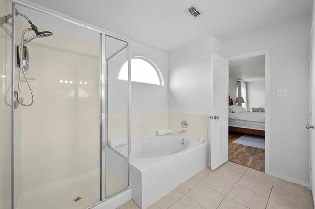 a bathroom with a bathtub and a shower