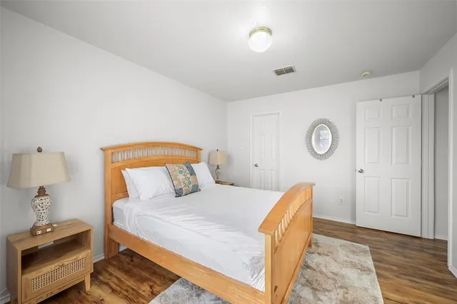 a bedroom with a bed and a lamp